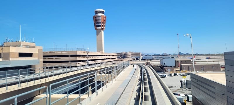 A view of an airport with a tower in the background.