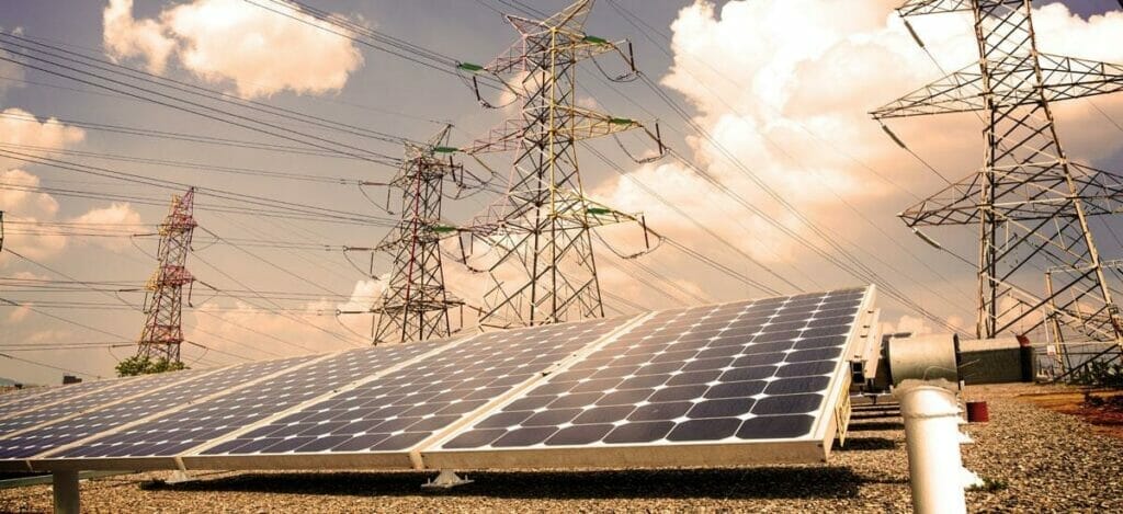 Solar panels on top of a power line.