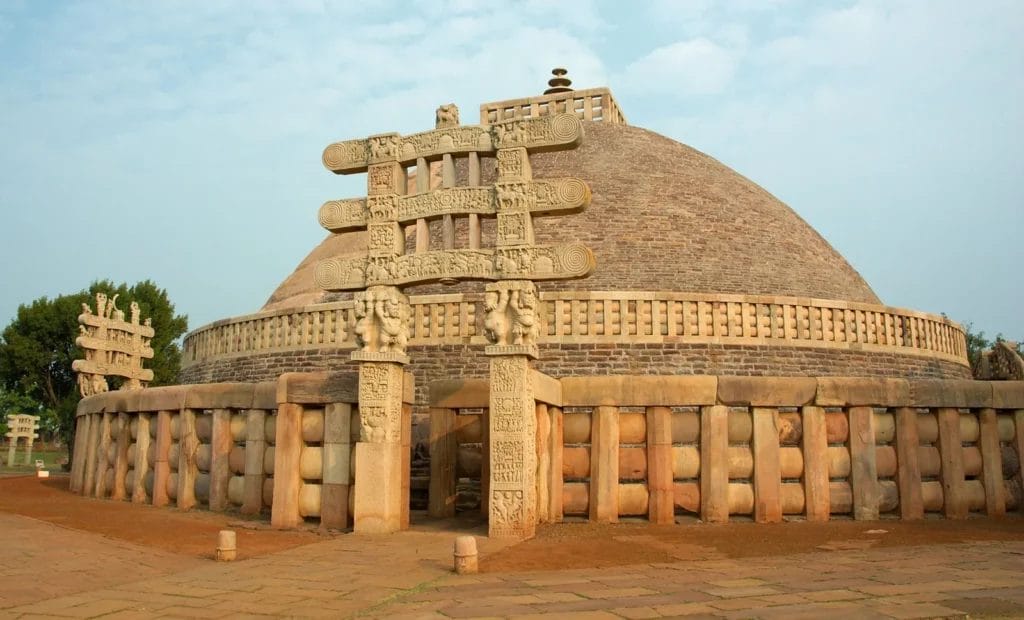an old stone building with Sanchi in the background