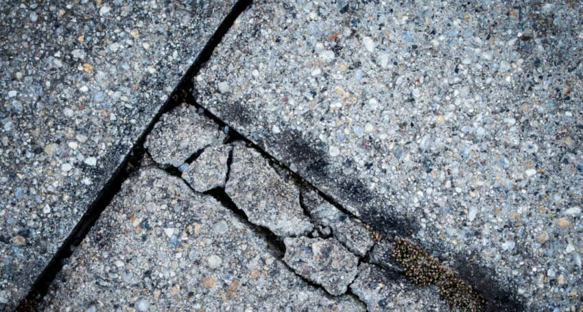 An innovative close up of a crack in a sidewalk showcasing civil engineering projects.