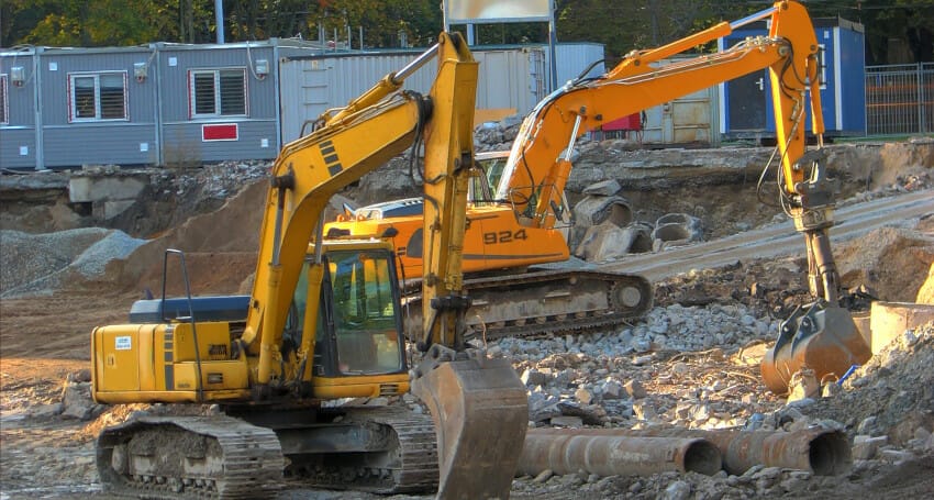 A yellow excavator used by civil engineers.