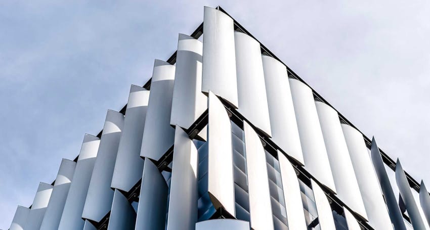 The facade of a building is covered in innovative white cladding.